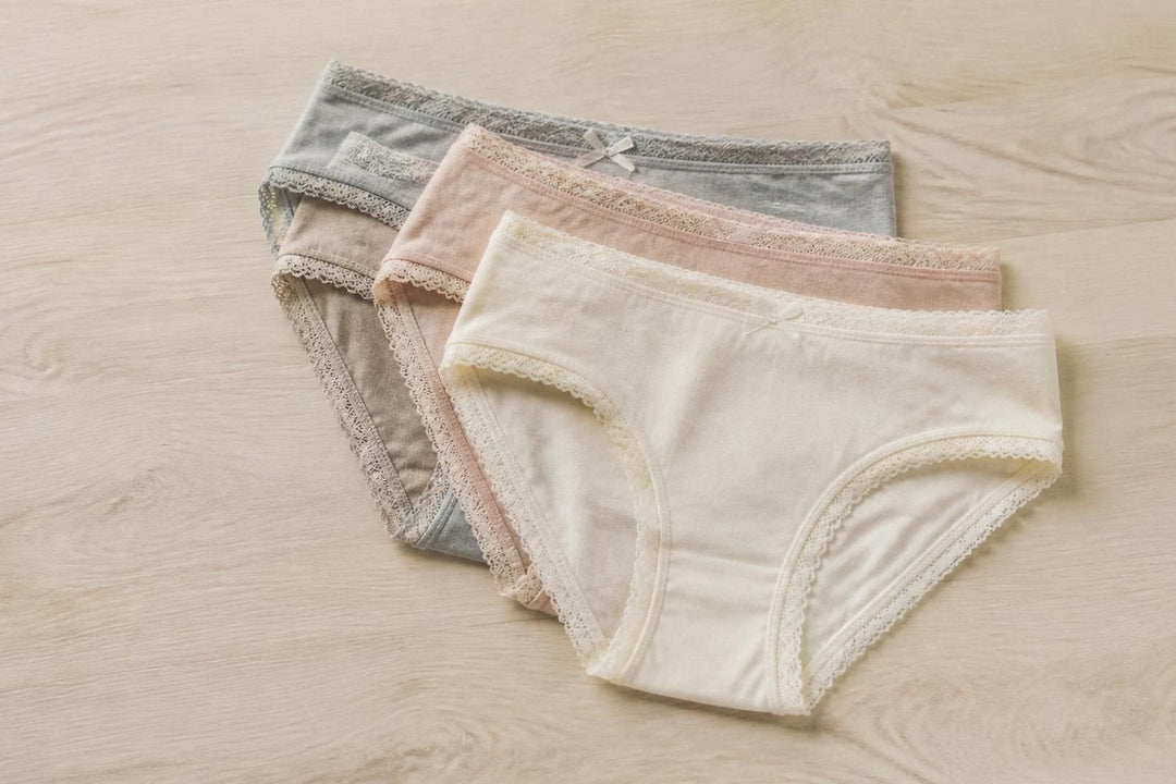 A stack of folded briefs in neutral shades